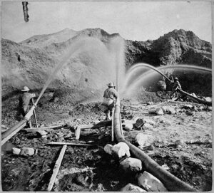 water cannons spraying water into mountainside